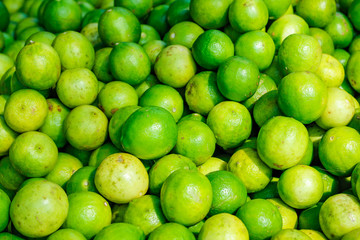 Green and yellow lemon in indian vegetable market 