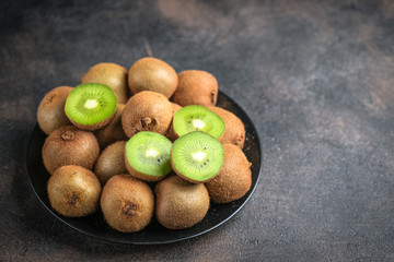 Fresh ripe kiwi fruit on  a dark  background. Detox diet. Copy space.
