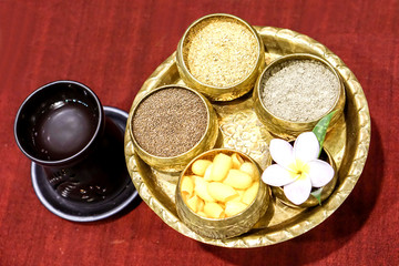 Components for polishing for Thai spa on red woven background.