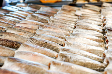 Dried gourami fish lined up for sale to customers in the market.