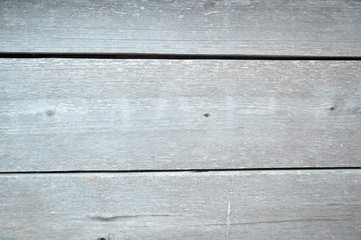 Wall of three gray boards. Old darkened wooden boards. Dark gray background.