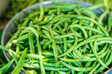 Fresh green long bean bunch in basket 