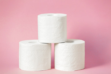 Roll of white toilet paper on colored background