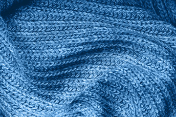 Knitted scarf texture. Classic blue color. The concept of cozy, comfort, warm, softness or winter