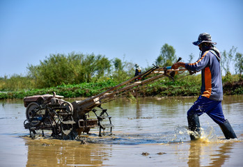 One farmer is using a motor to grow rice in Asian countries.