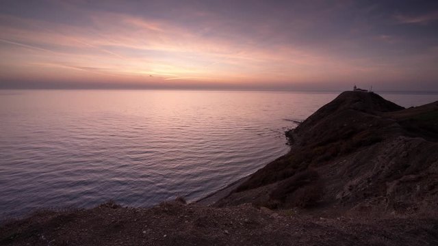 Night to day time lapse with the lighthouse at Cape Emine, surrounded by sea and mountain slopes - Black sea coast, Bulgaria. 4K Time lapse.