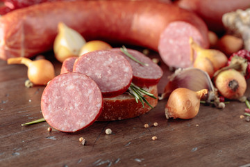 Sandwich with salami on a old wooden table.