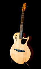 A portrait of a hand made guitar on a black background.