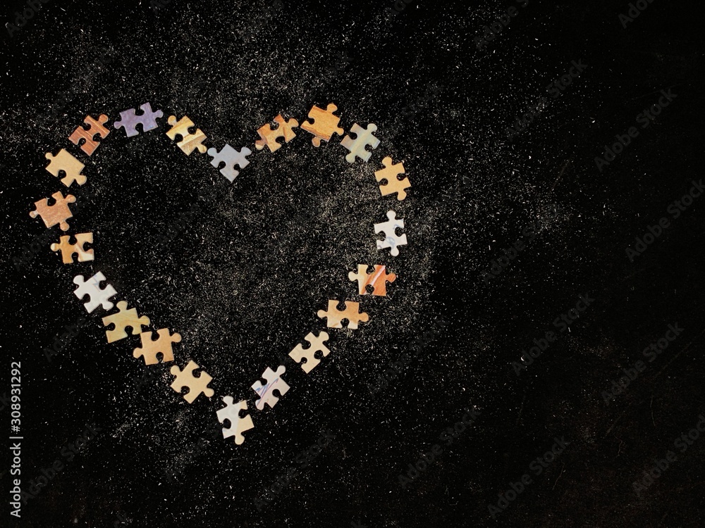 Poster background texture: heart shape on puzzle paper background. puzzle in the details in the form of a m