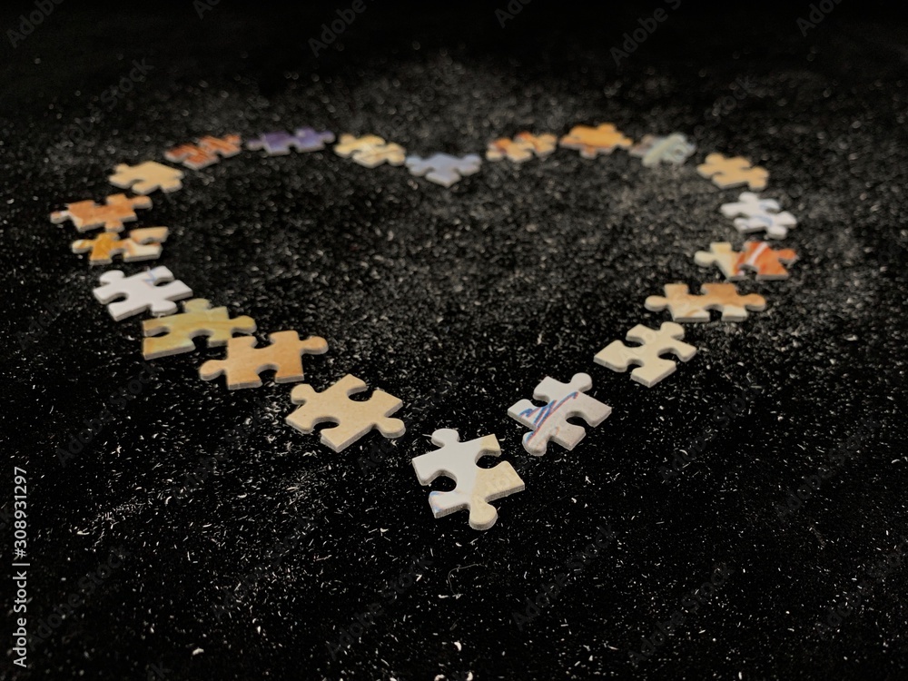 Poster background texture: heart shape on puzzle paper background. puzzle in the details in the form of a m
