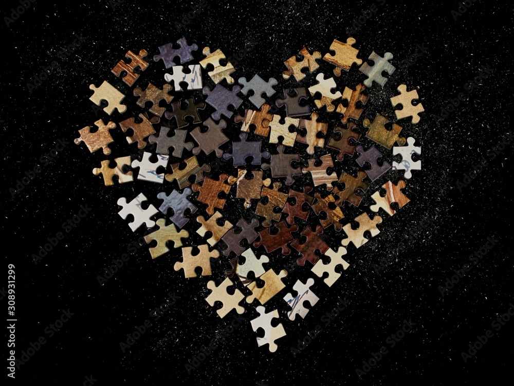 Poster background texture: heart shape on puzzle paper background. puzzle in the details in the form of a m