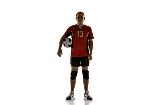 Young caucasian volleyball player placticing on white background. Male sportsman posing confident with the ball, prepared for win. Sport, healthy lifestyle, activity, movement concept. Copyspace.