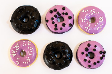 Fototapeta premium Colorful donuts on the table. close up view. copy space