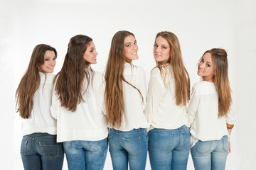 Group of happy girls turning their heads back to camera