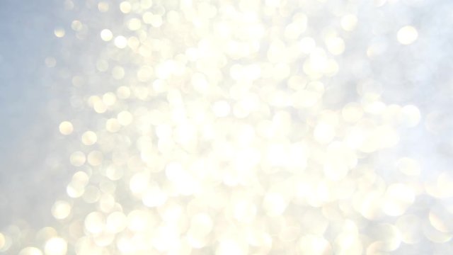 Decorative defocused abstract silver background with sparkling glitter. Festive and holiday background for text. 4k footage.