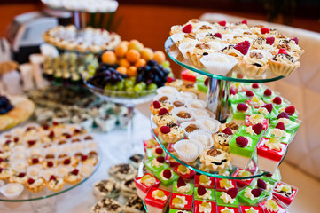 Dessert table of delicious sweets on wedding reception.