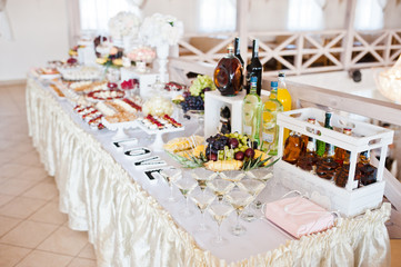 Dessert table of delicious sweets on wedding reception.