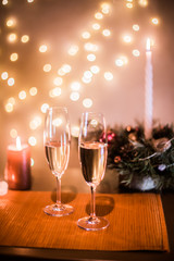 Christmas champagne on a table against the background of garlands
