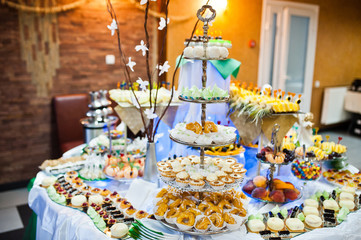 Dessert table of delicious sweets on wedding reception.