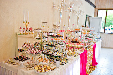 Dessert table of delicious sweets on wedding reception.