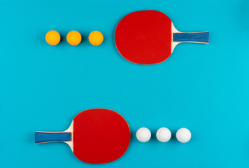 Ping pong racket and ball on blue background