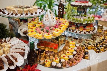 Dessert table of delicious sweets on wedding reception.