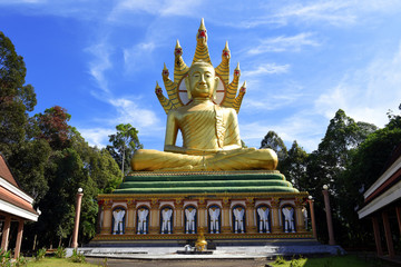 Fototapeta na wymiar Golden Giant Buddha - Wat Bang Riang, Wat Rat Upathamin, temple in Khao Lan mountains of Phang Nga Province, Thailand