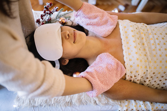 SPA therapist scurb girl chest with pink gloves