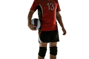 Fototapeta premium Young caucasian volleyball player placticing on white background. Male sportsman posing confident with the ball, prepared for win. Sport, healthy lifestyle, activity, movement concept. Copyspace.