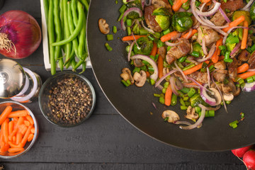 Culinary background, frying meat with vegetables.
