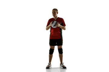 Young caucasian volleyball player placticing on white background. Male sportsman posing confident with the ball, prepared for win. Sport, healthy lifestyle, activity, movement concept. Copyspace.