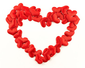 Obraz premium Valentines Day Heart Made of Red little cloth material hearts Isolated on White Background. Big Red Love Heart / seamless close up gift card / wedding