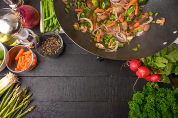 Culinary background, frying meat with vegetables. With space.