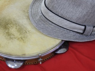 Close-up of a samba player (sambista) hat and a Brazilian percussion musical instrument: 