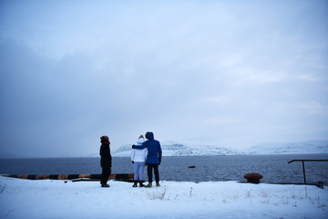 tourists on the observation deck look at the sea to see whales and killer whales in the Russian Arctic