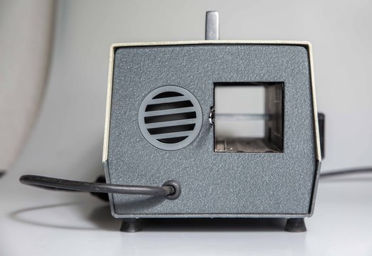 Manchester, England, 12/11/19 Halina  HalinaMat Slide Projector for 35mm film photographs photo slides Vintage retro photography equipment shot in studio on white background isolated. Grey projekter