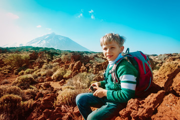 Naklejka premium boy hiking in mountains, child travel in Teide national park, Tenerife, Spain