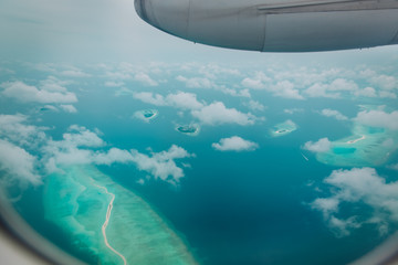 Naklejka na ściany i meble Beautiful aerial view from the plane over Maldives islands