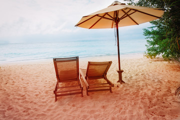 Two beach chairs on tropical vacation, relax at sea