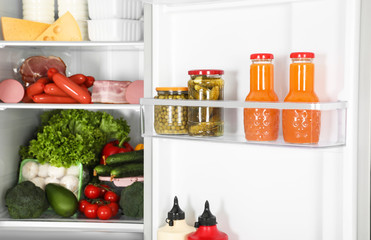 Open refrigerator full of different fresh products