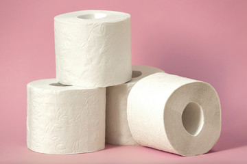 Roll of white toilet paper on colored background