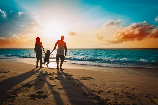 happy family with kids on play on sunset beach