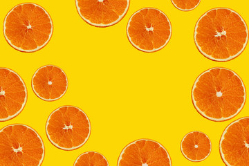 texture with juicy slices of orange, lemon, lime on a yellow background for a menu or recipe, concept of vegetarian, vitamin and wholesome food, background, pattern for textile, wallpaper, copy space