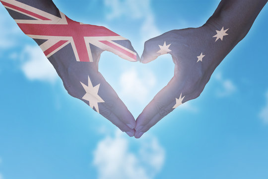 Australian flag painted on hands in heart shaped. Australia day.