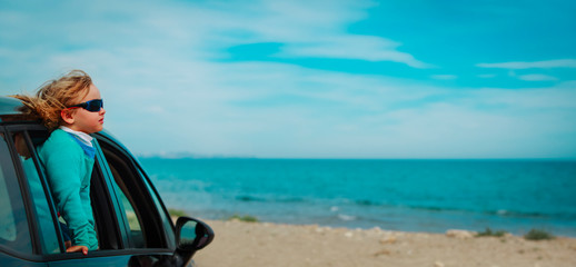 happy little girl enjoy travel by car at sea, panorama