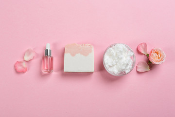 Flat lay composition with natural handmade soap and ingredients on pink background