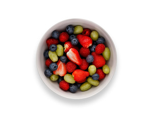 A bowl full of delicious fresh summer fruits, isolated on white