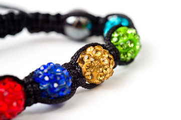 woven bracelet with multi-colored round beads on the arm