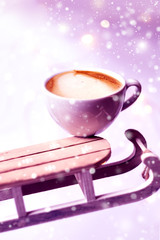 Winter cappuccino coffee in a white cup on a sleighs