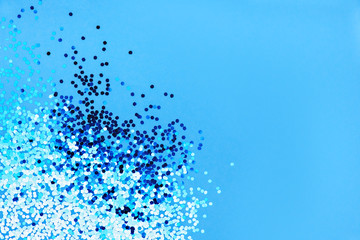 Colored sequins on blue background.